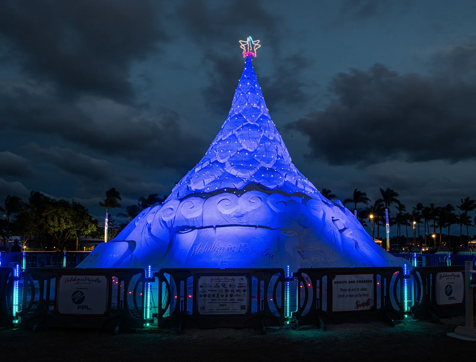 The Sandi Tree, a lighted Christmas tree sculpted from sand, at Centennial Square on the waterfront in West Palm Beach.