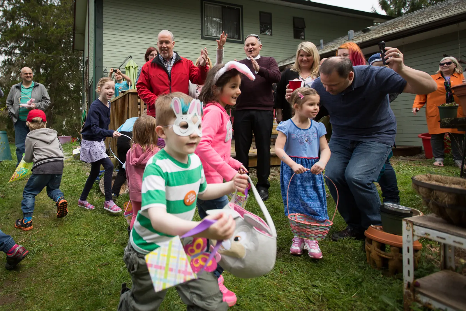 Children in bunny masks run for eggs at a community Easter egg hunt in Maple Ridge, British Columbia.