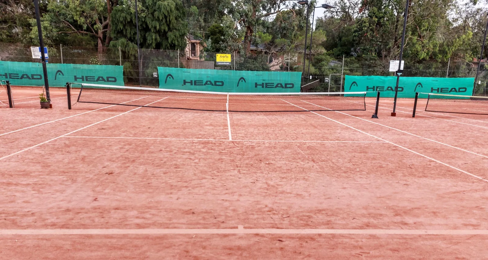 An empty clay tennis court in Melbourne, Australia; the Wellington Tennis Center has 24 clay courts.