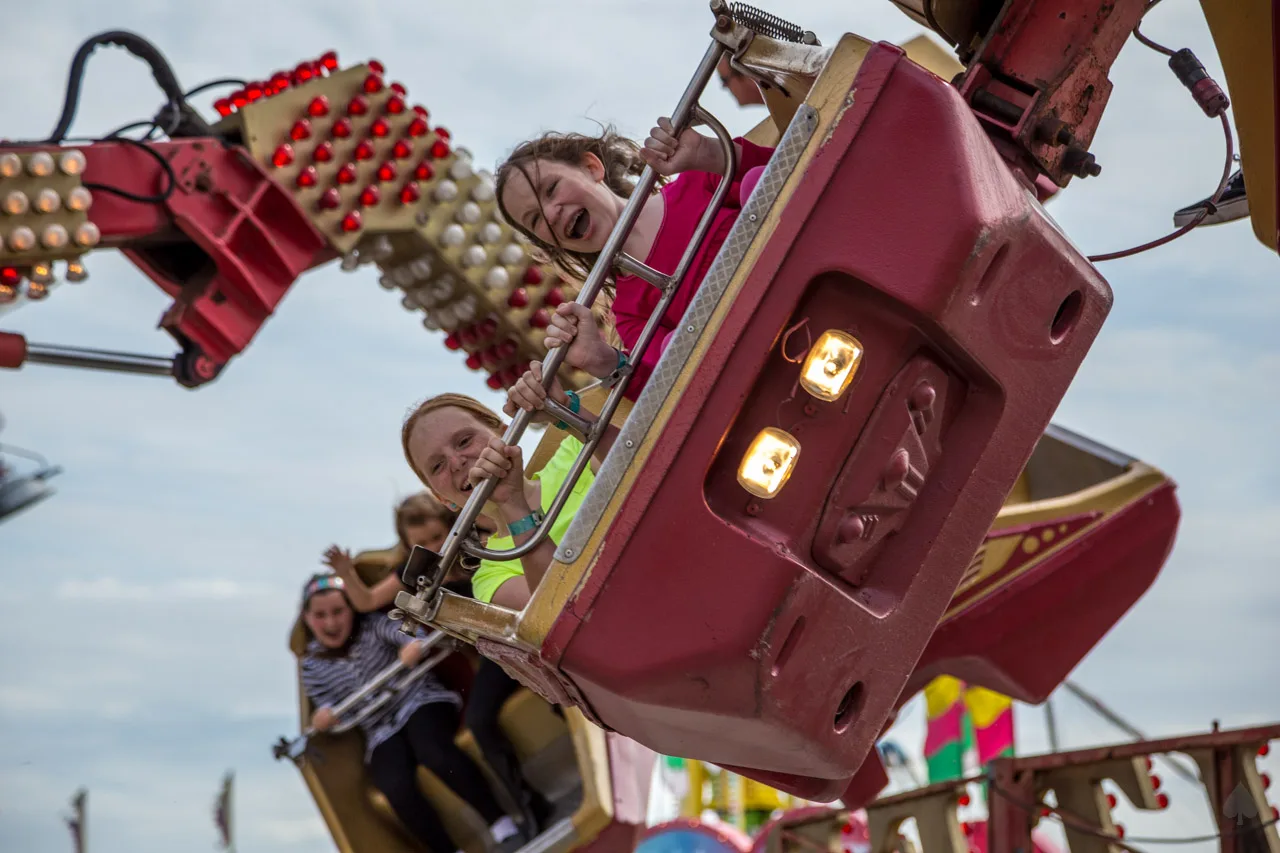 Children ride a carnival ride at the St. Coleman Italian Festival in South Florida.