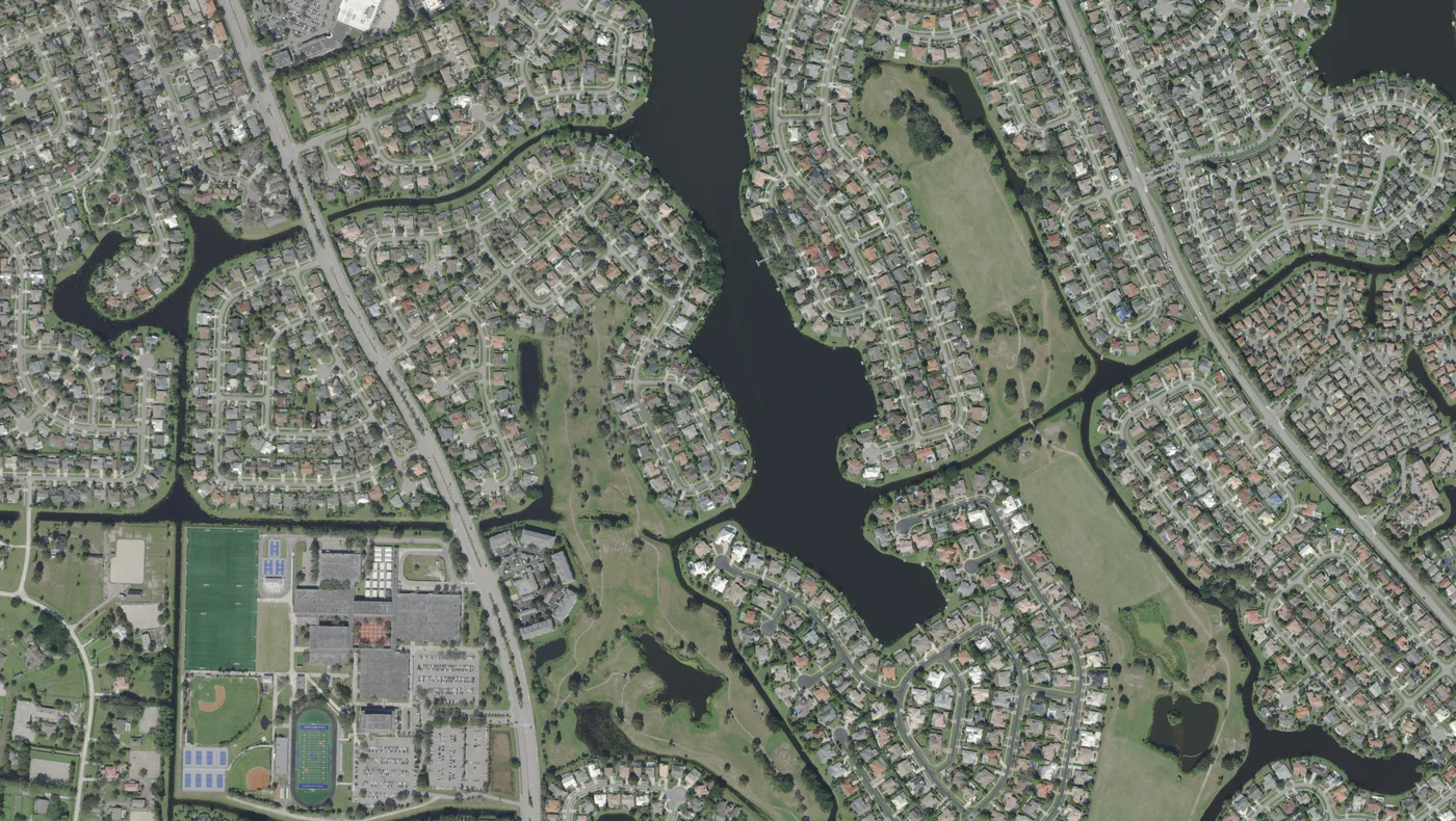 Lakes, a golf course, school fields and streets of homes along Greenview Shores Boulevard in central Wellington, in a USDA aerial photograph from 2022.