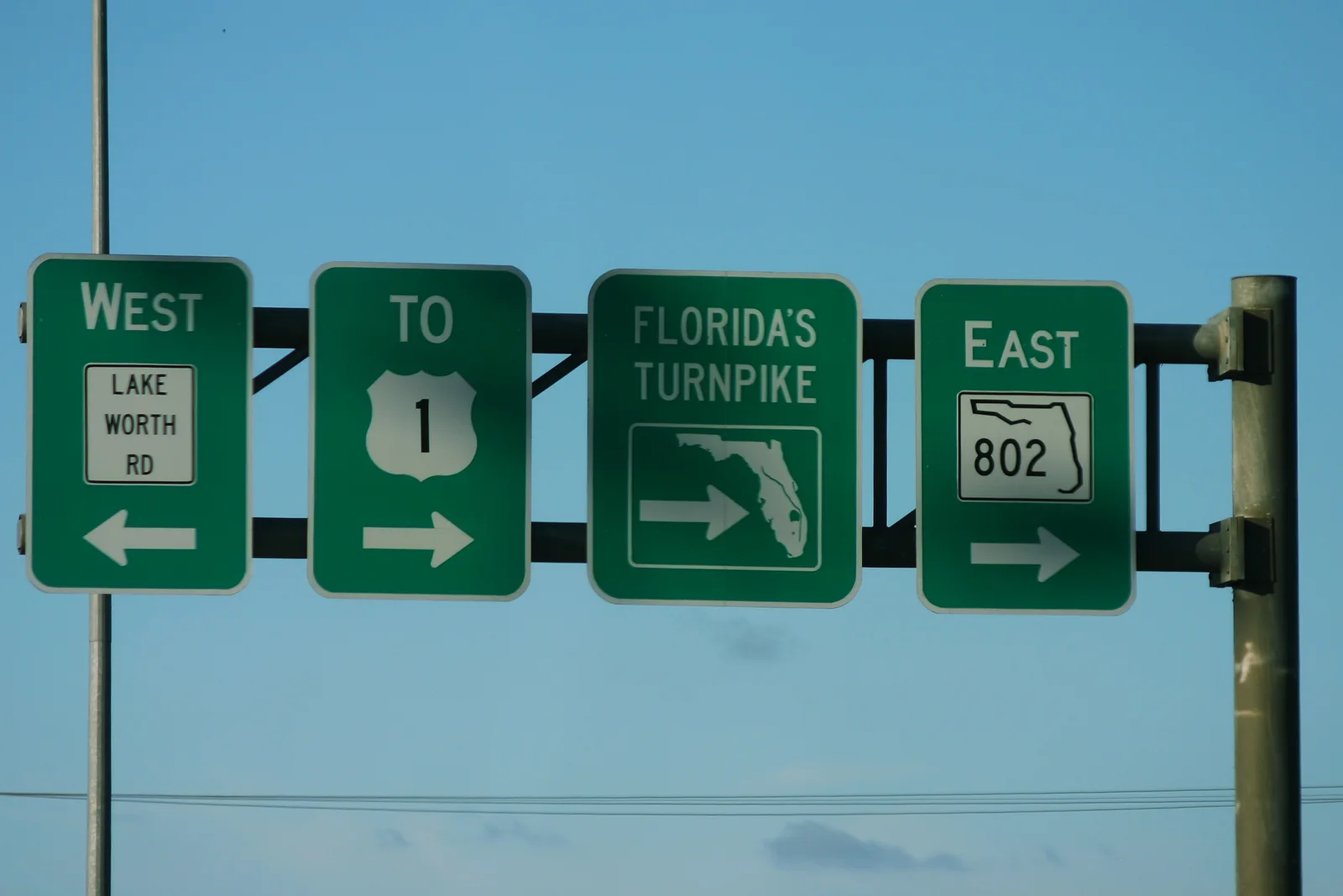 Signs for Lake Worth Road (State Road 802) and Florida's Turnpike on U.S. 441, at the southeast corner of Wellington's Lake Worth Road communities.