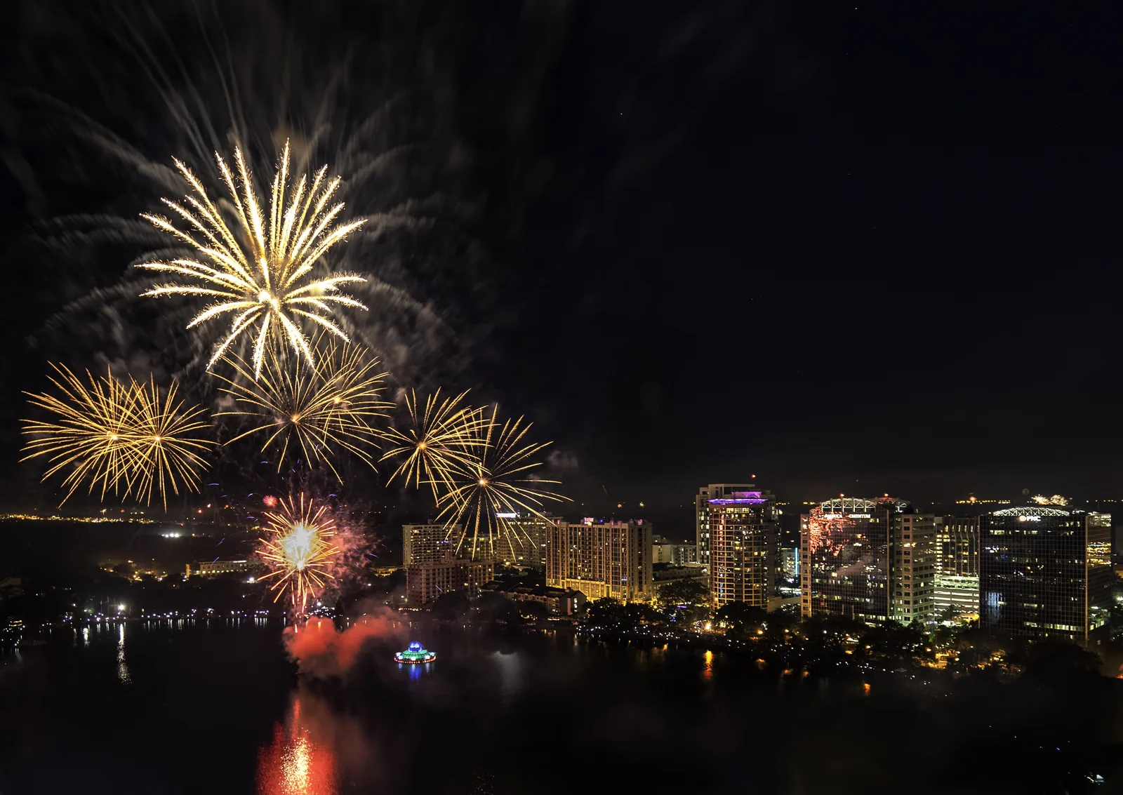 Fireworks burst over Lake Eola and the downtown Orlando skyline.