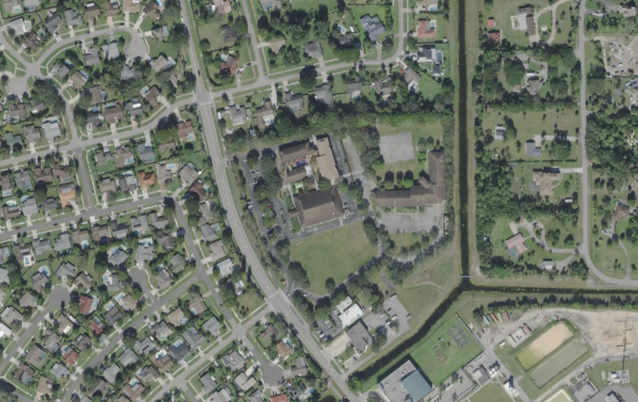 The Somerset Academy Wellington campus at 1000 Wellington Trace from the air, among the homes of central Wellington