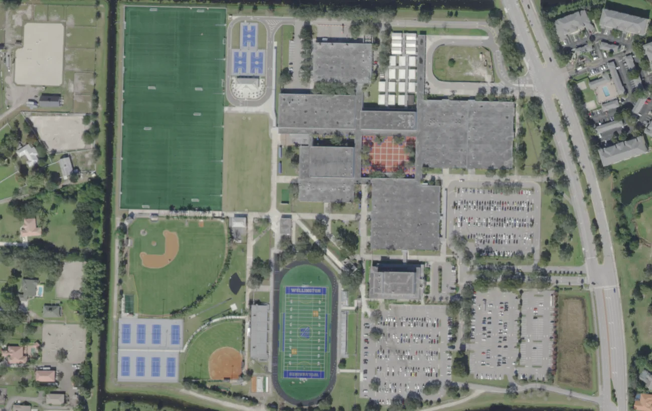 Wellington Community High School's campus on Greenview Shores Boulevard from the air, with its stadium, ball fields and tennis courts