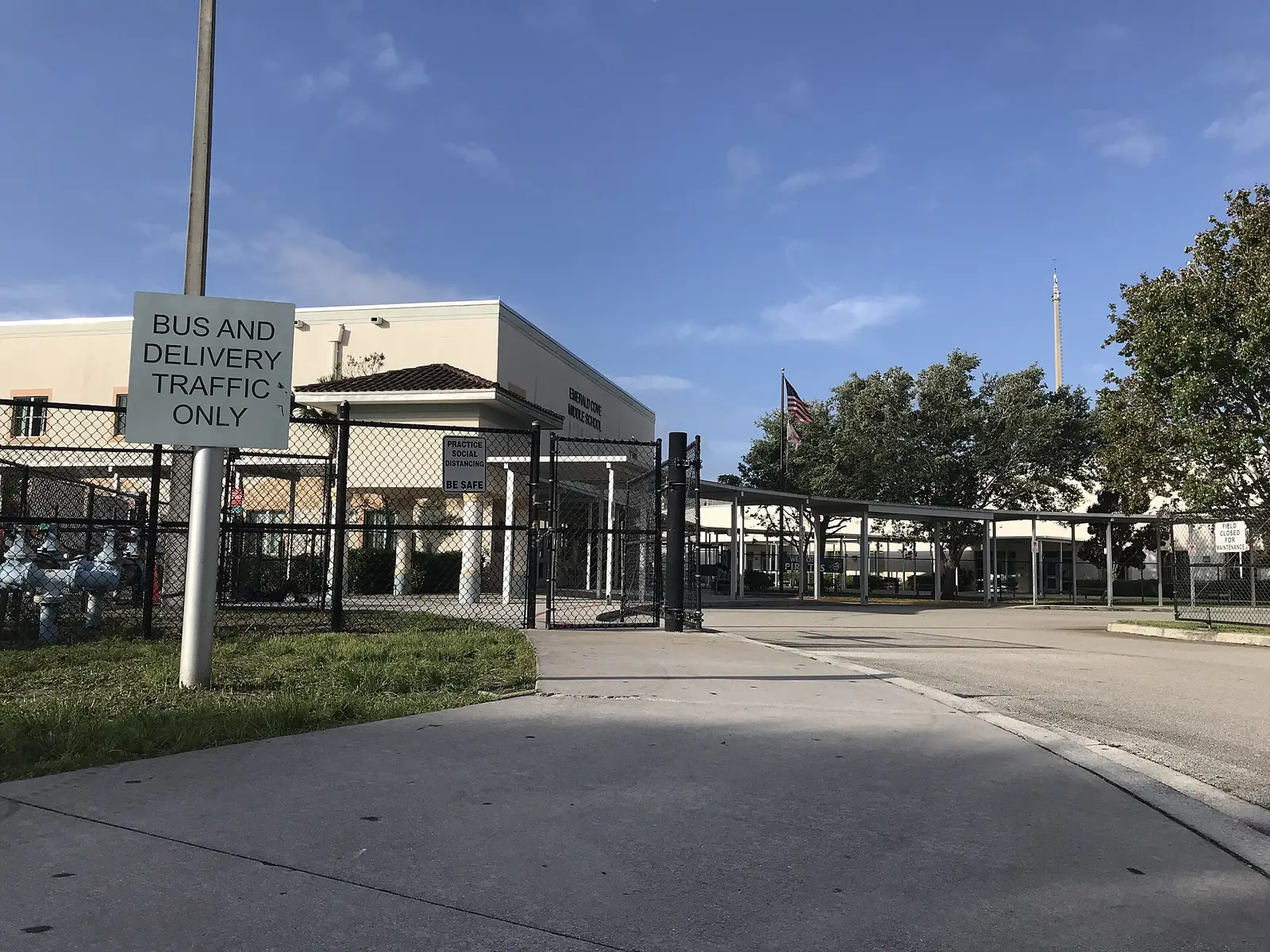 The bus and delivery entrance of a public middle school in Wellington in the early morning.